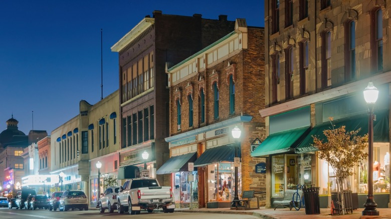 Brick two and three-story buildings of downtown Marquette in the late evening with street lights on