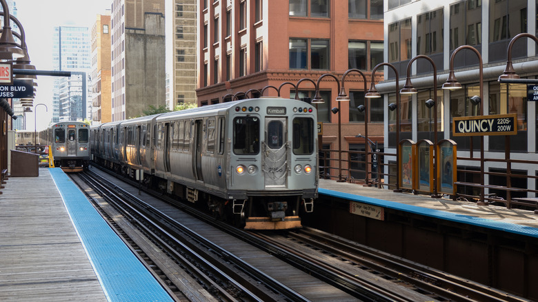 Trains arrive at an L station in Chicago