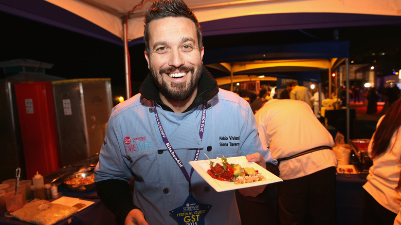 Chef Fabio Viviani holds a plate of food