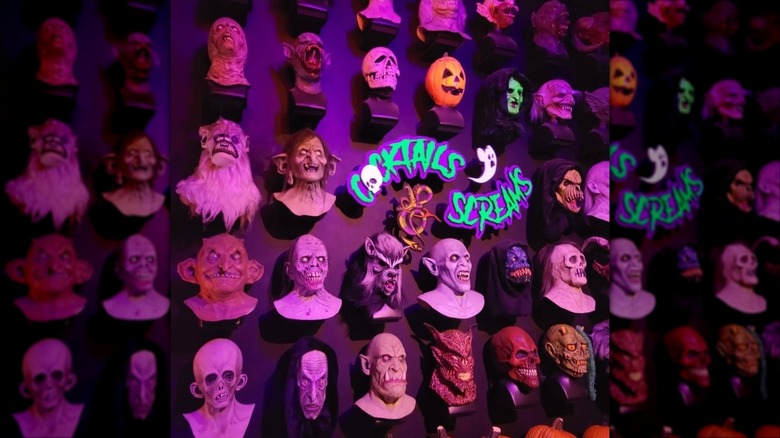 A wall of monster masks at Cocktail & Screams, Orlando, Florida