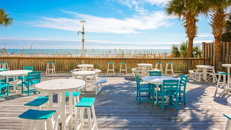 A waterfront Myrtle Beach cafe with blue and white tables and chairs