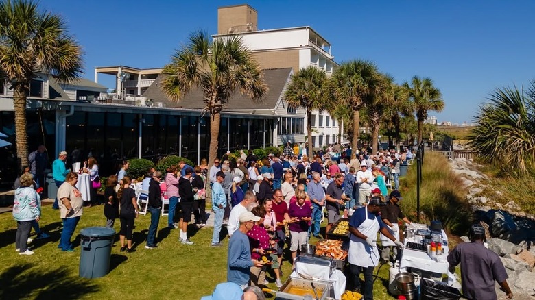 People gathered on the Sea Captain's House lawn for food in Myrtle Beach