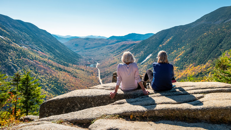 Hikers gazing at scenic White Mountains in New Hampshire
