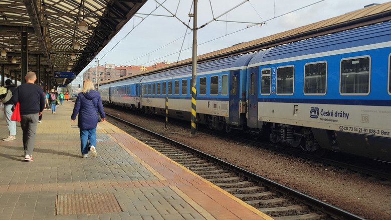 Czech Republic train station with people walking along platform