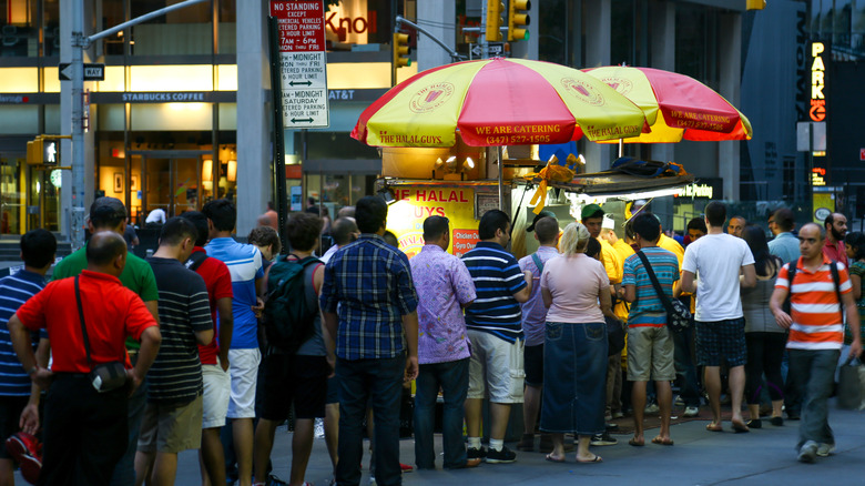 Line of people at a food cart in New York City