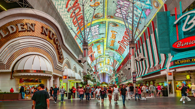 People walking down Fremont Street in Las Vegas, with 1950s casinos on either side