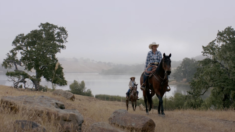 Horseback riders next to a lake in Alisal Ranch