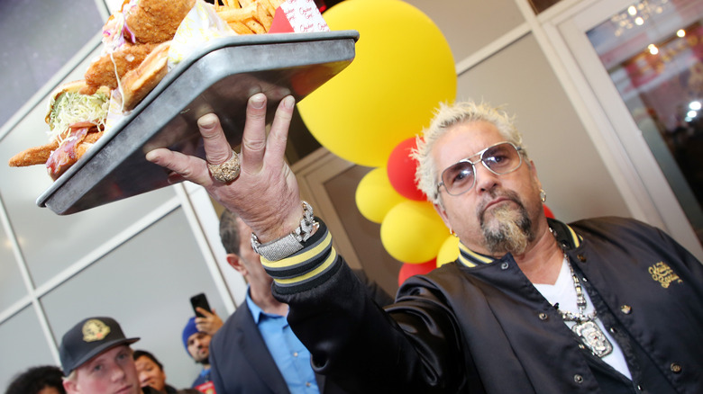 Guy Fieri with a tray of food