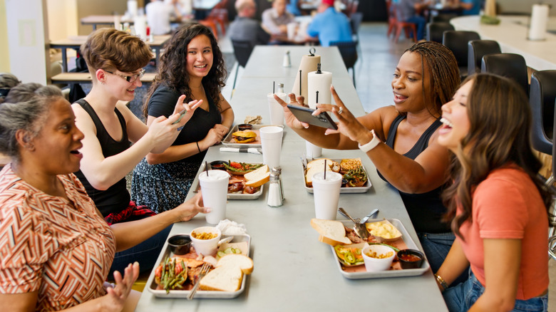 A group of friends eating together at a barbecue restaurant in Houston, Texas