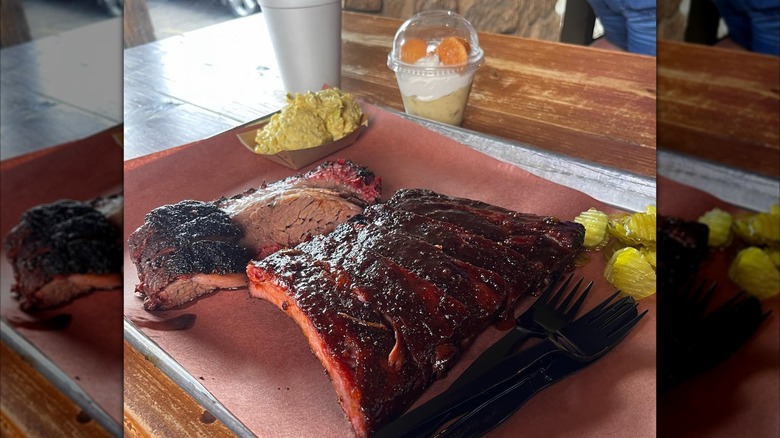 A plate of barbecue meats and pickles at Pinkerton's Barbecue in Houston