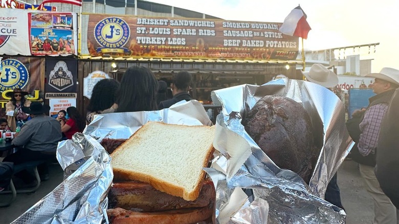 A sandwich and turkey leg from Triple J's Smokehouse stand at a food festival in Houston