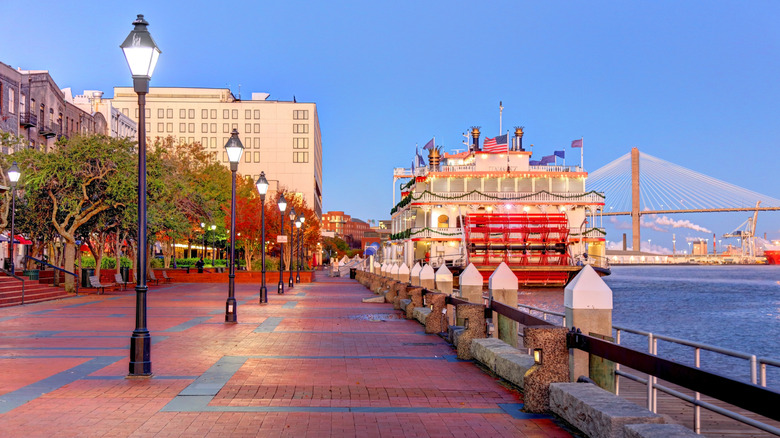 Boat and walkway on Savannah river walk at dusk