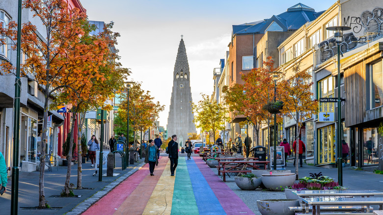 Pedestrians walking on Reykjavík's Rainbow Street on a clear autumn day