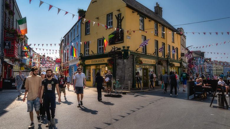Tourists walking through the streets of Galway on a sunny day
