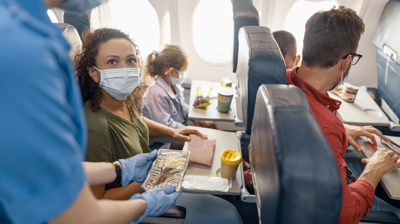 Passengers wearing face masks while flying