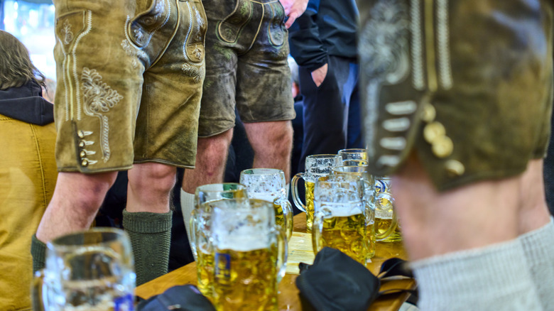 People at the Augustiner standing on the benches while the tables remain clear
