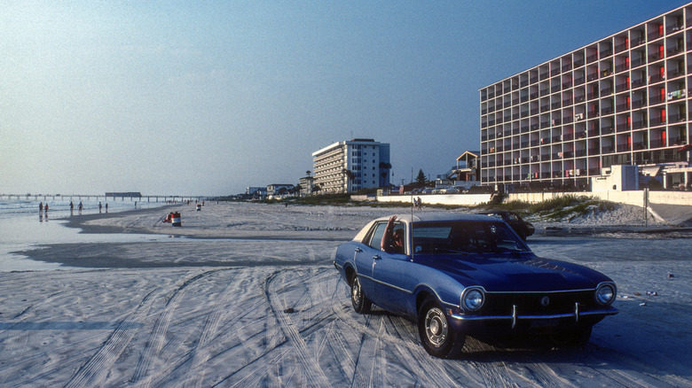 Car on the sand of Daytona Beach in the 1970s