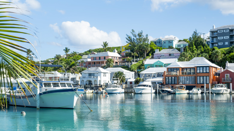 Yachts sit at the docks below coastal homes in Bermuda