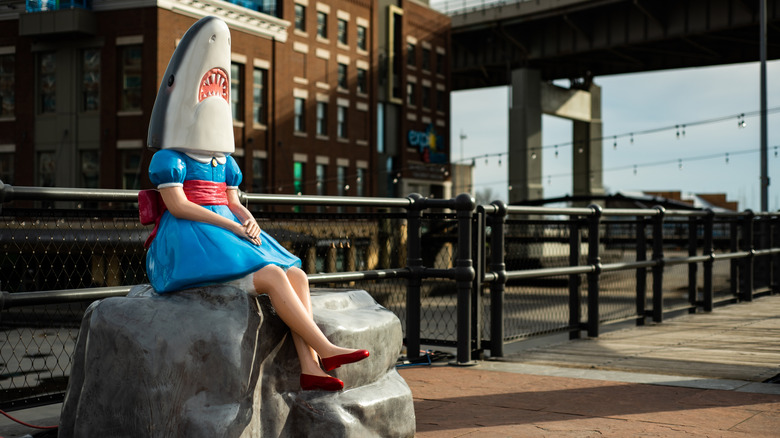 The statue of Shark Girl sits on a rock at Canalside in Buffalo