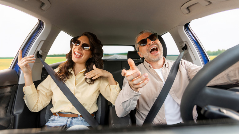 Couple singing in the car on a roadtrip