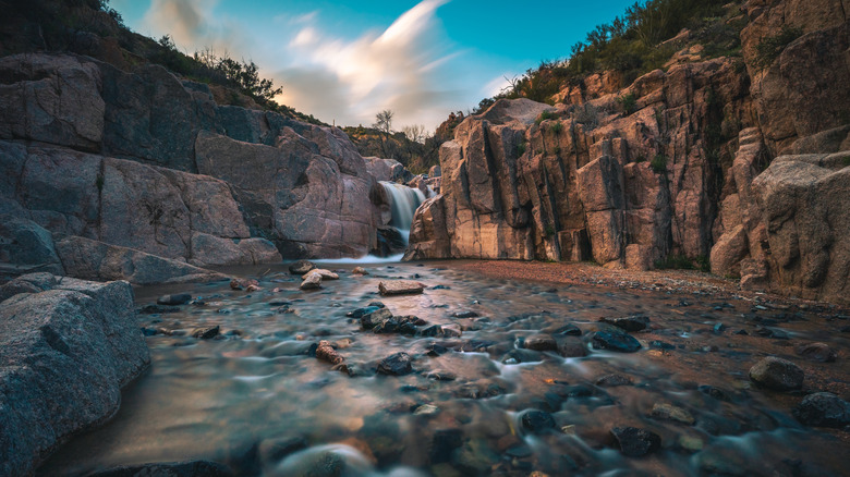 A waterfall flows at sunset in Tonto National Forest outside of Phoenix, AZ