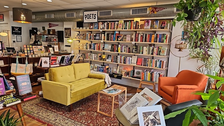 Interior of Stay Gold Books, with a full-wall bookshelf under a sign reading 