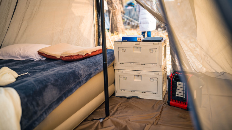 Interior view of a camping tent with a propane heater inside
