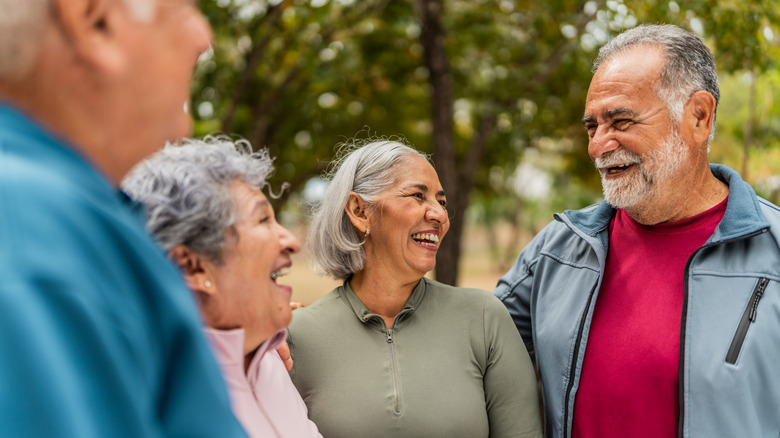 Four older people smiling