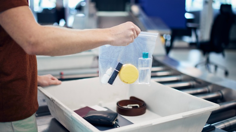 Man holding plastic bag in airport