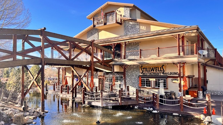 Stillwells Restaurant and Lounge with bridge going across on water blue sky Holiday Inn Resort the Lodge