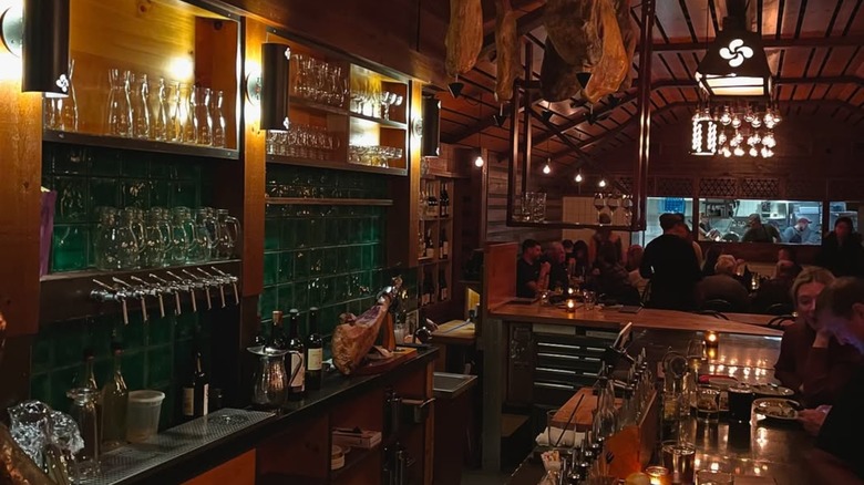 The bar at Morcilla in Pittsburgh with jamon legs hanging from the ceiling