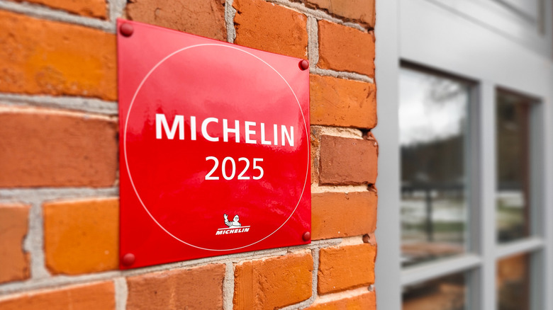 Bright red Michelin logo affixed to brick wall