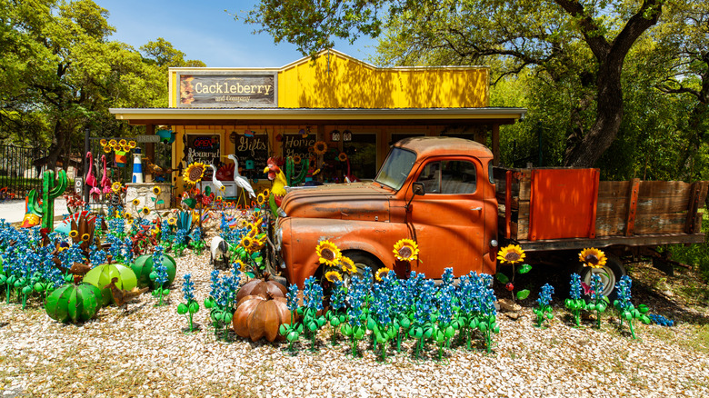 Colorful quirky storefront in downtown Wimberly Texas with flowers and vintage truck