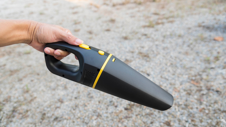 Someone using a handheld vacuum