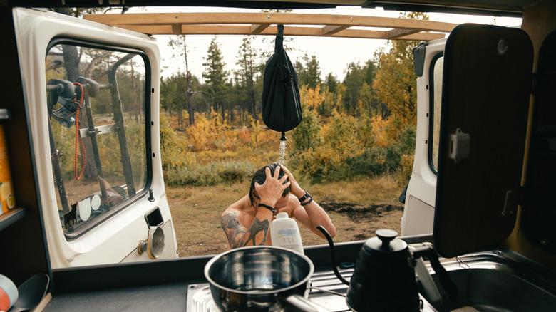 Person using an outdoor shower in an RV