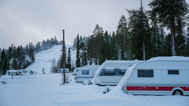 Camper vans in the snowy forest