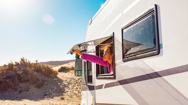 A woman opening her RV window