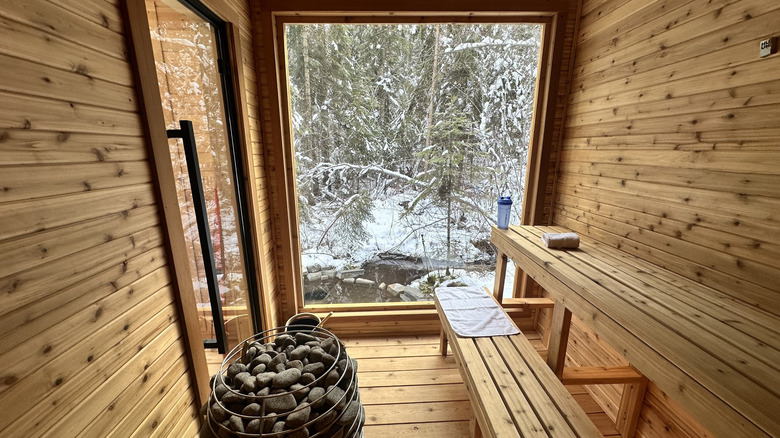 Interior of the sauna at Cabins at Blacktail with views of the spring and forest outside