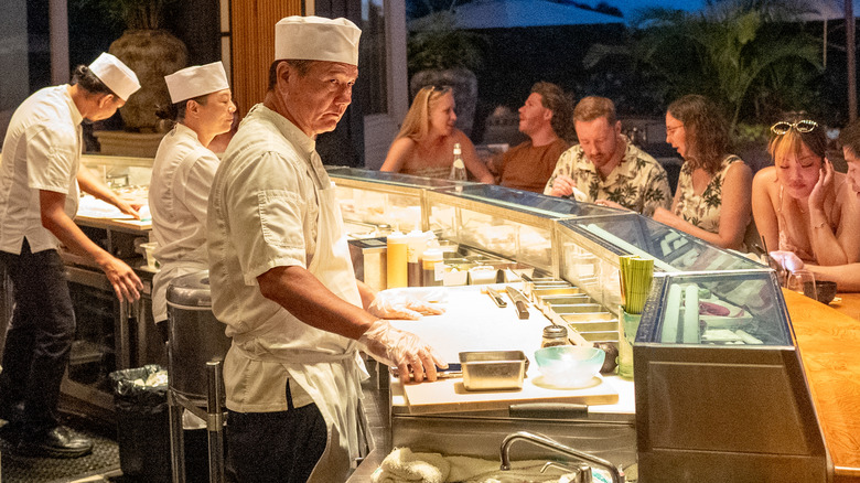 Sushi chefs behind the bar at a sushi restaurant