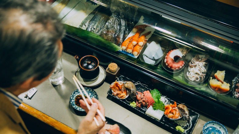 A lavish and elegant spread laid out in front of a diner at a sushi bar