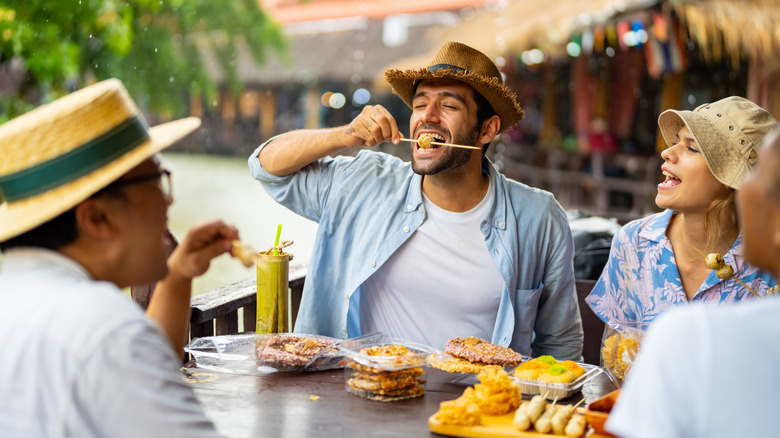 A group of people eat at a Thai restaurant in Ayutthaya, Thailand.