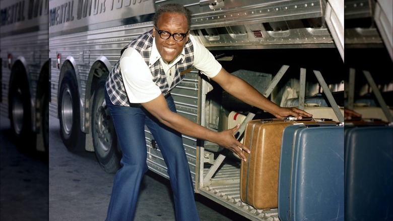 Driver unloading cases from a bus