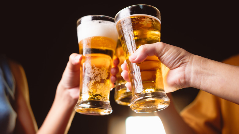 Man and woman raising a beer glass