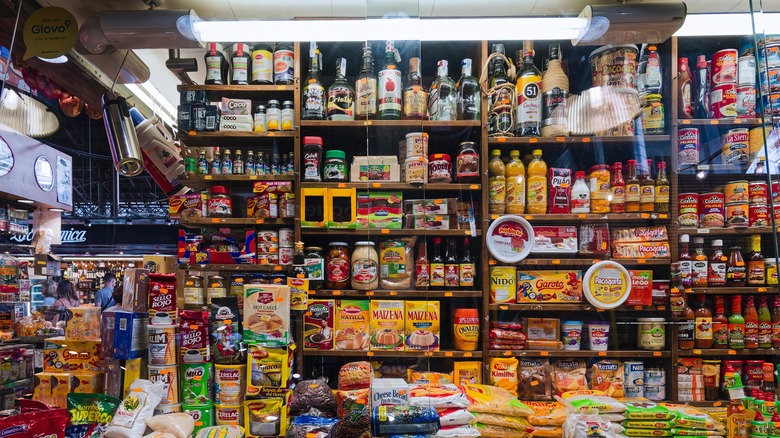 Walls in a small Spain grocery store are lined with cooking products