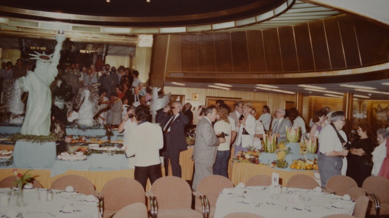 A large group of people gathered for a midnight buffet on a cruise ship