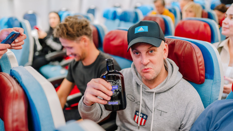 Drinking from the bottle on a plane