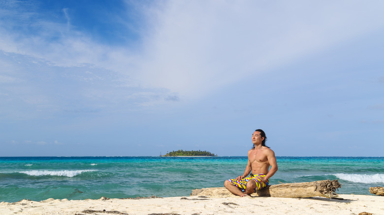 a man subathes on a beach on San Andrés Island, Colombia