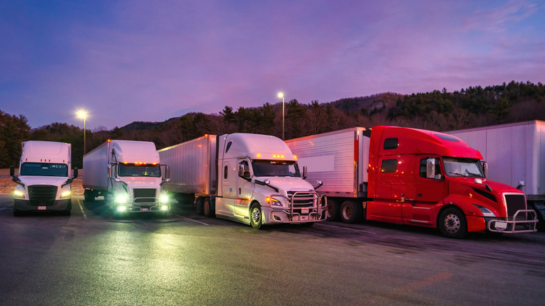 Trucks lined up at a truck stop at night