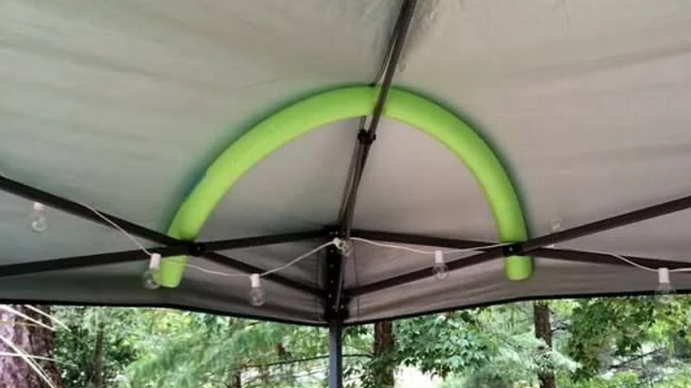 Pool noodle bent inside the corner of a canopy tent