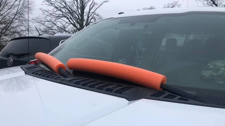 Orange pool noodles on windshield wipers